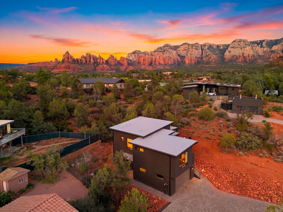 Casa Alta at sunset with the red rock skyline behind it.