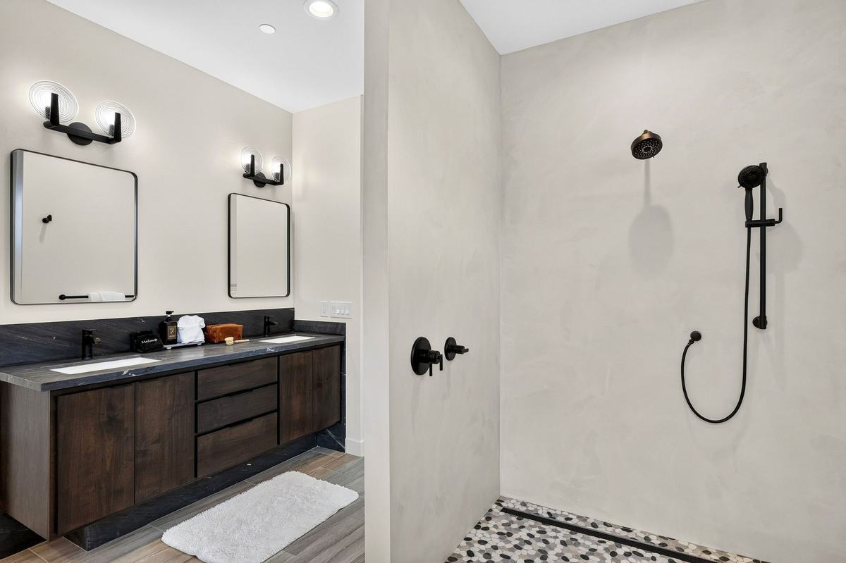 Primary bath with a double vanity and a walk-in shower.