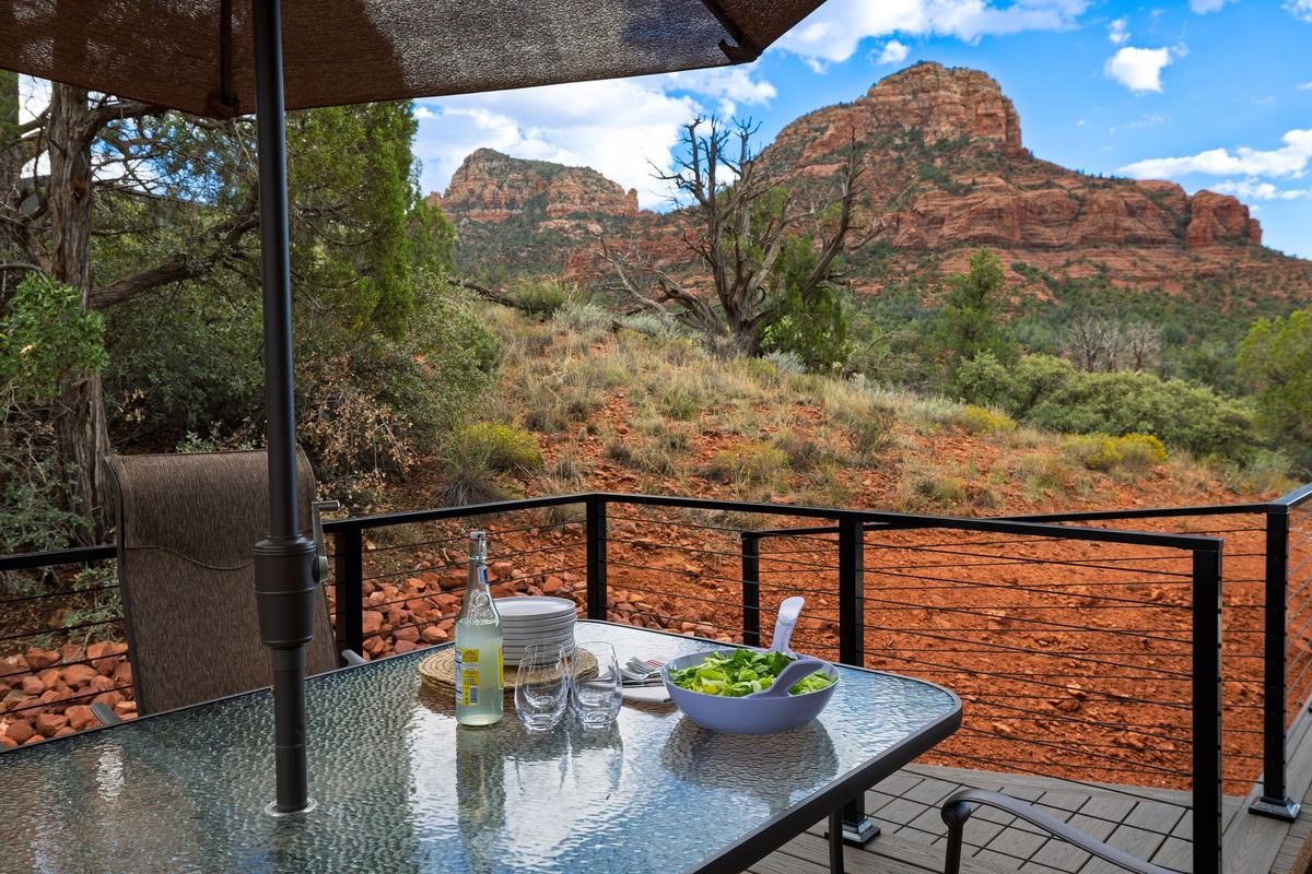 Outdoor dining table on the deck with Twin Buttes behind.