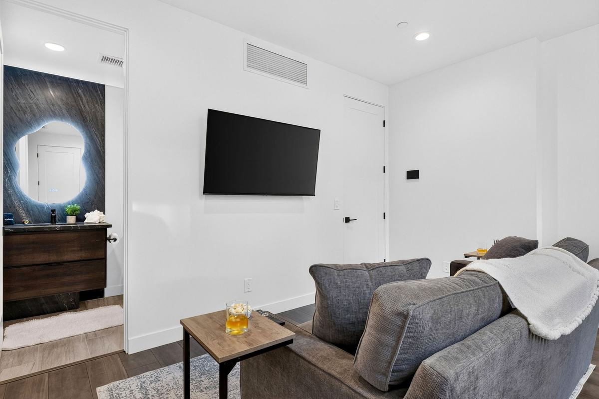 Family room with a sofa and wall-mounted TV.