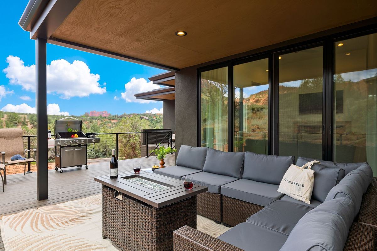 Covered lounge and grill with a view across the valley.